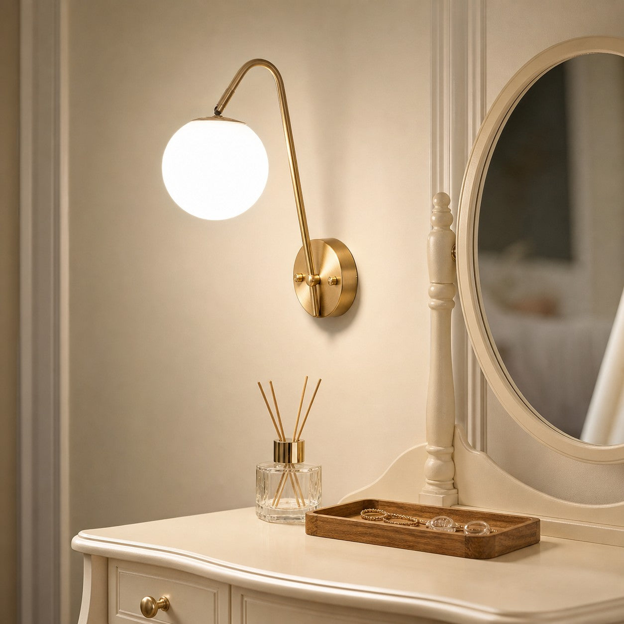 Brass globe wall light near a vanity and table setting