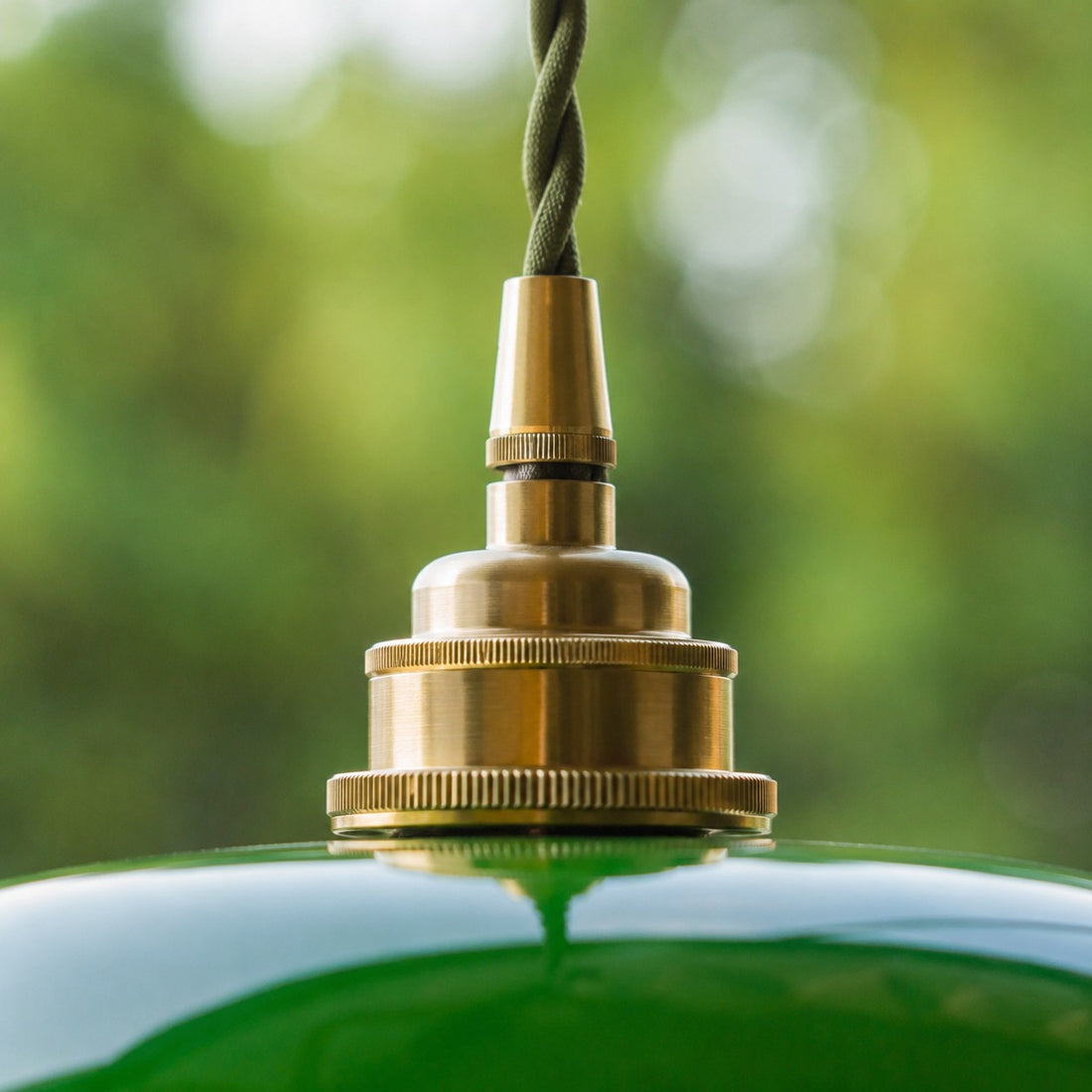 Close view of brass holder on green glass shade
