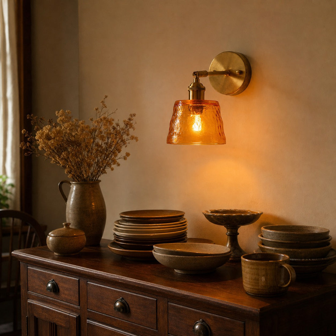 Amber brass glass wall sconce above a console