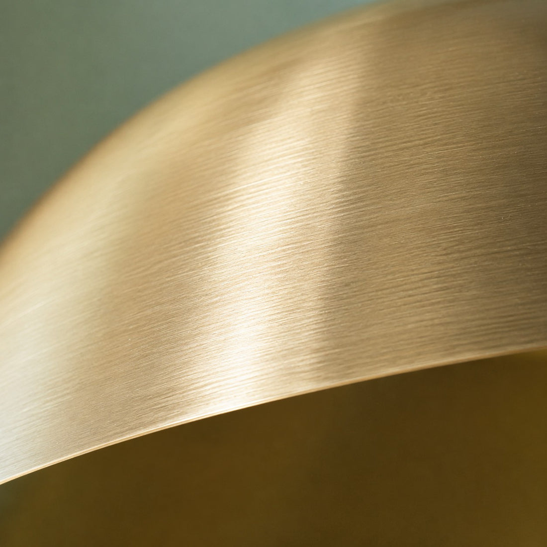 Close-up of the brushed brass finish on the copper dome shade
