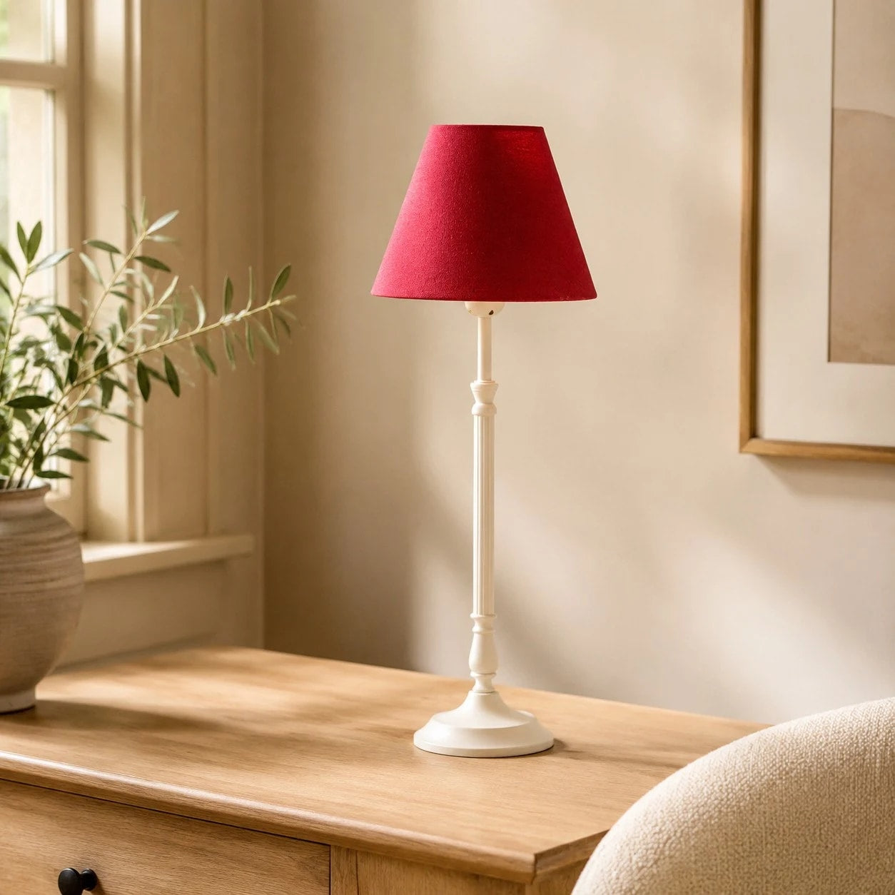 Rose red French country table lamp near a window