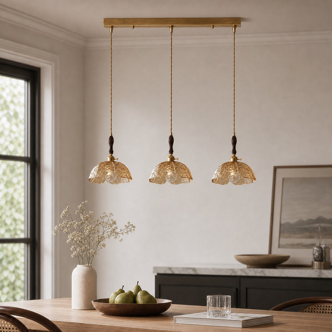Amber brass flower pendant above a dining table