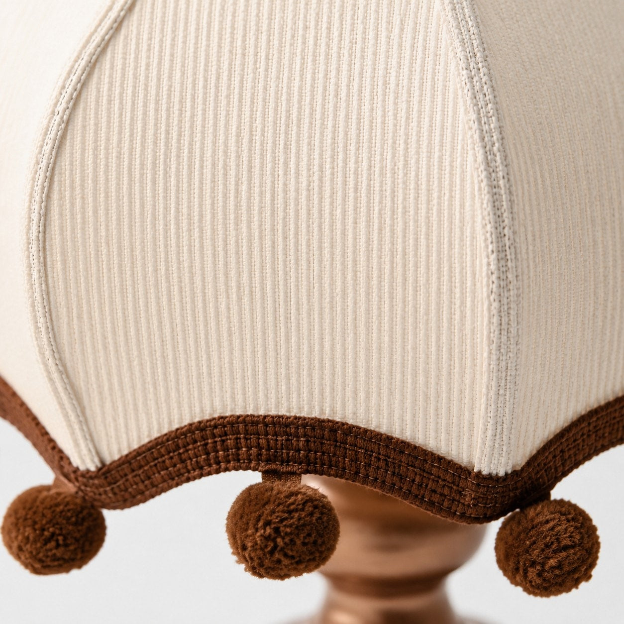 Pleated fabric shade and pom-pom trim detail