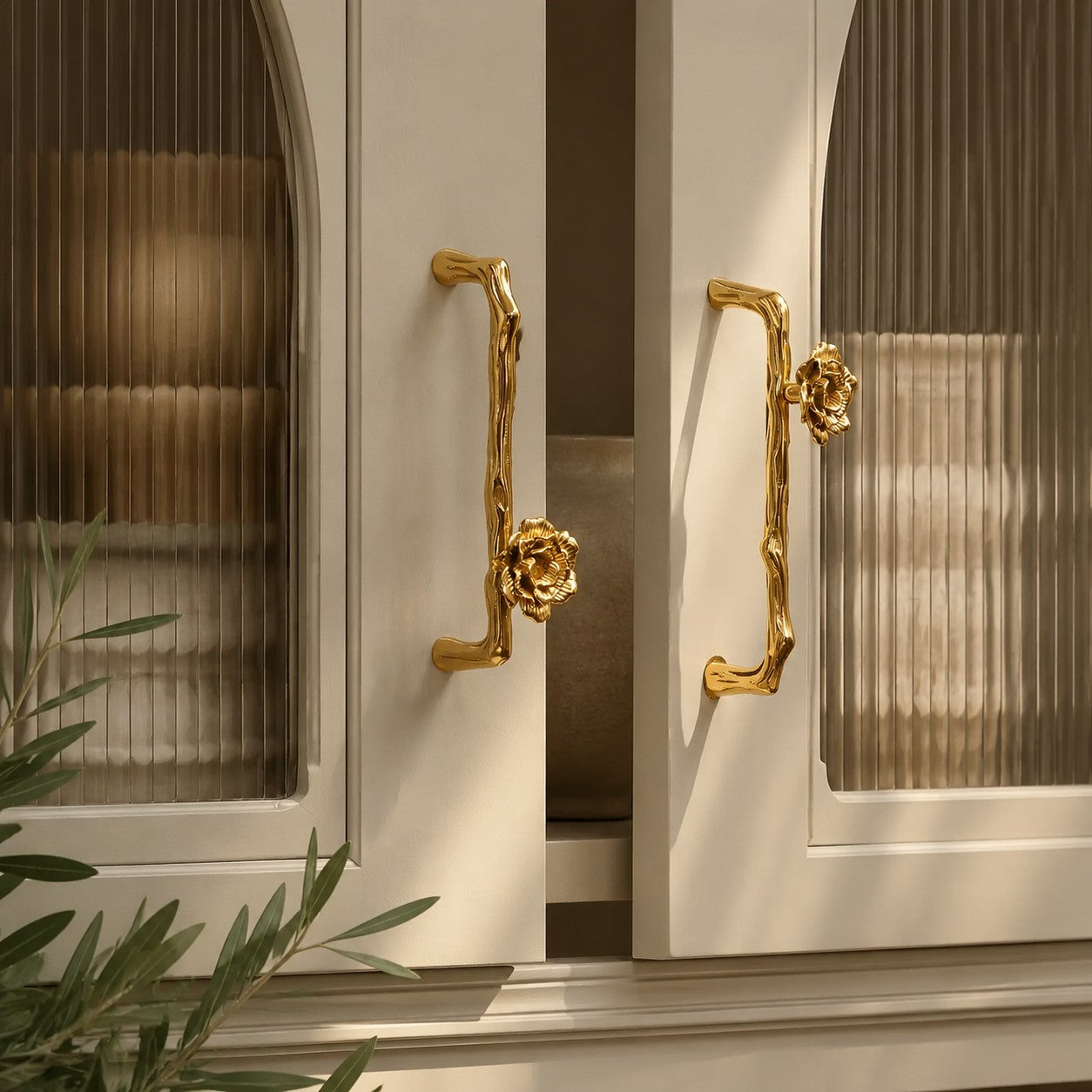 Sculptural brass cabinet handle installed on furniture