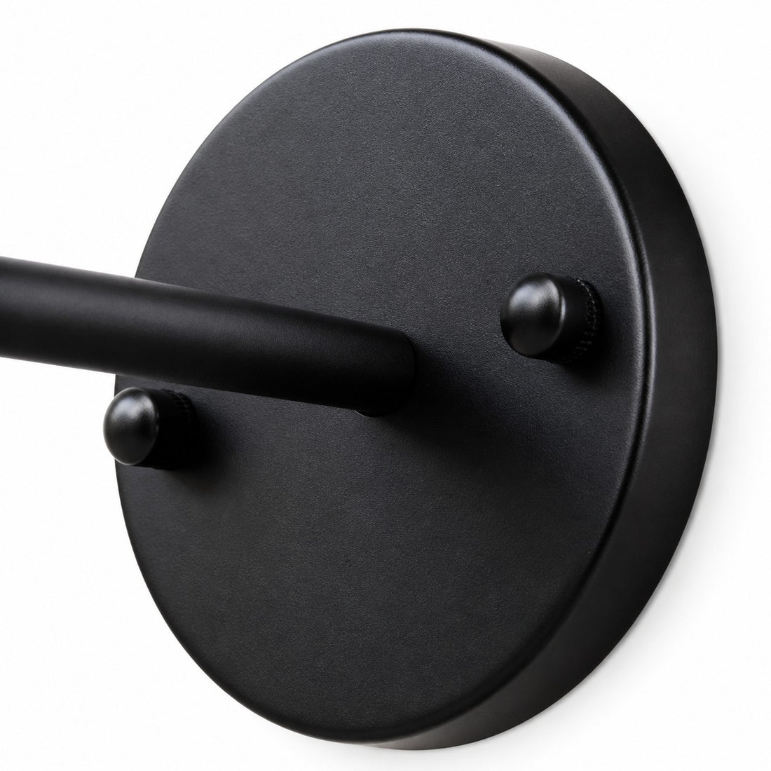Close view of black round wall plate and arm connection