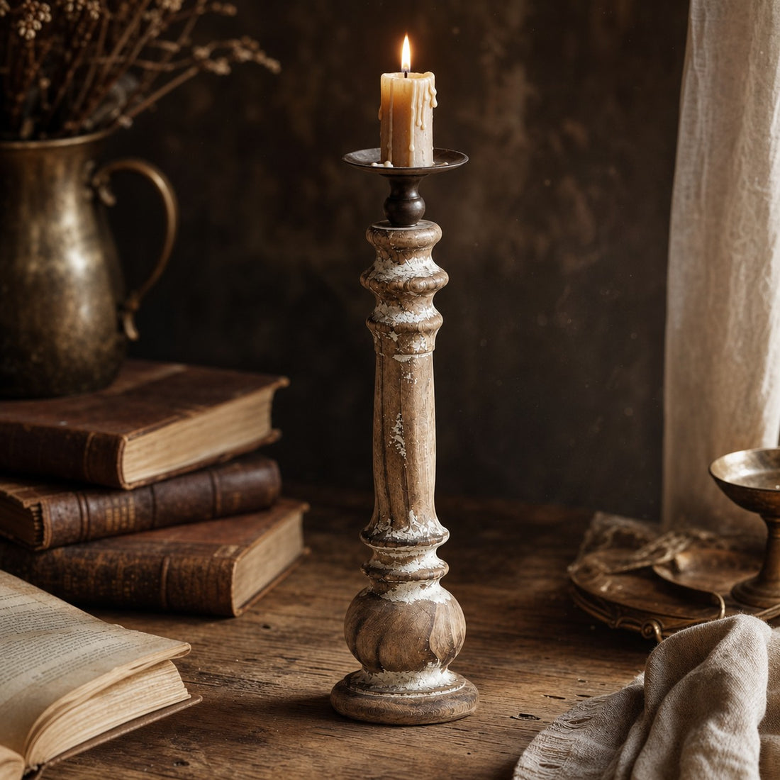 Short turned wood candlestick styled with a candle