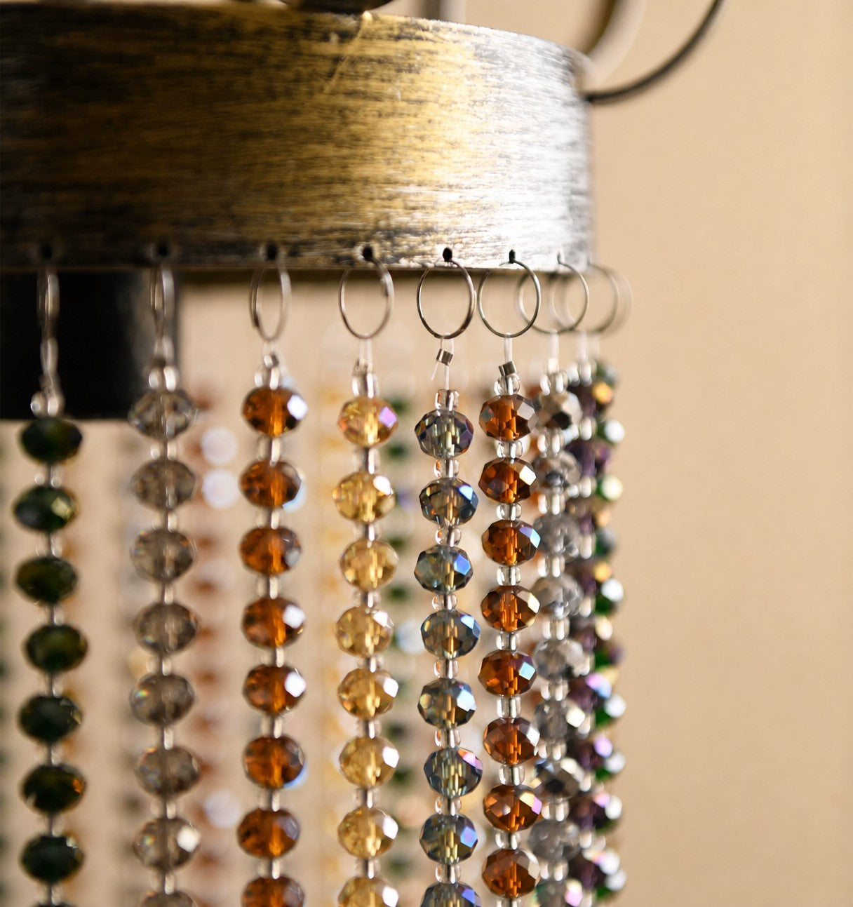 Close-up of curved black iron frame on crystal pendant light