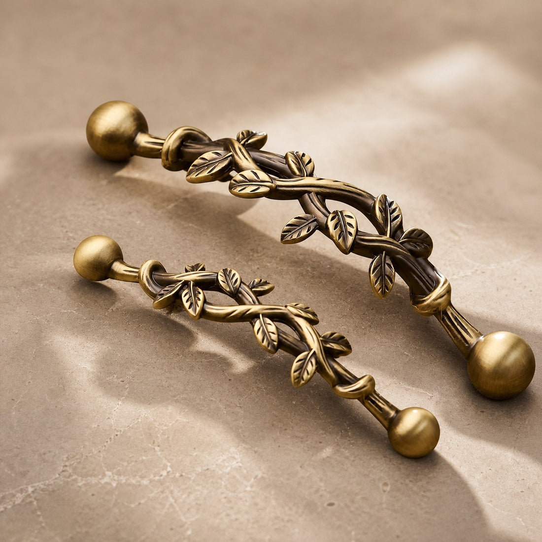 Antique brass leaf cabinet pulls shown from a side angle
