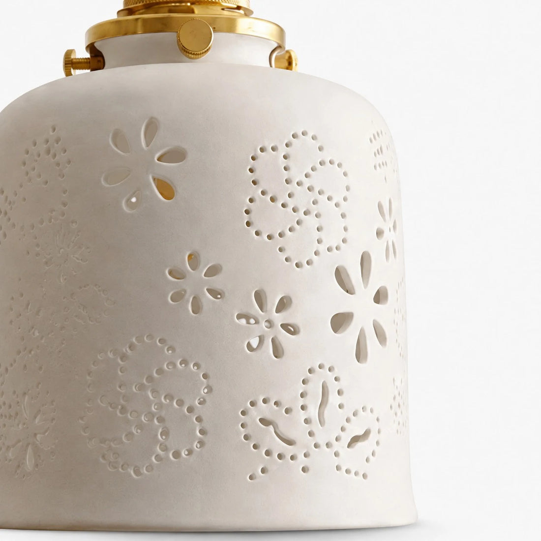 White ceramic lamp shade with perforated floral and dotted cutouts